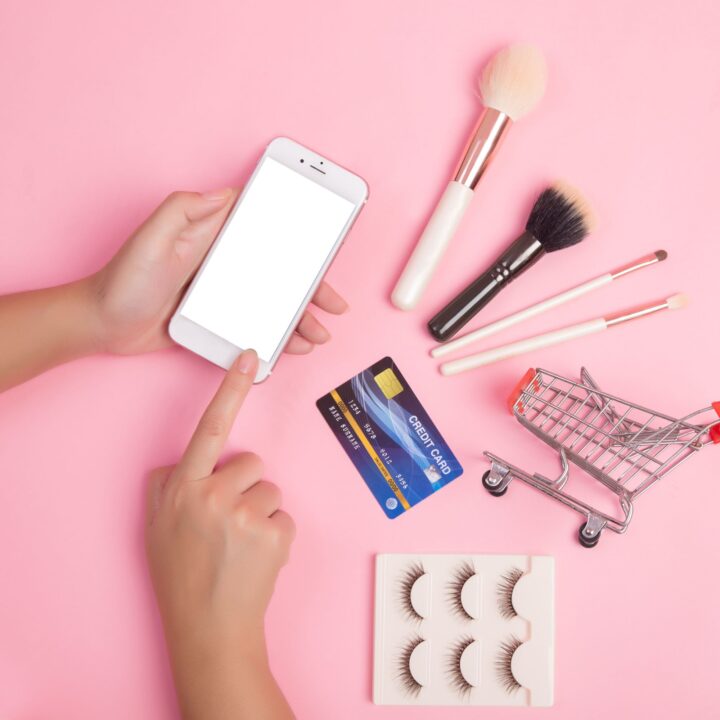 woman-using-smartphone-credit-card-shopping-beauty-items